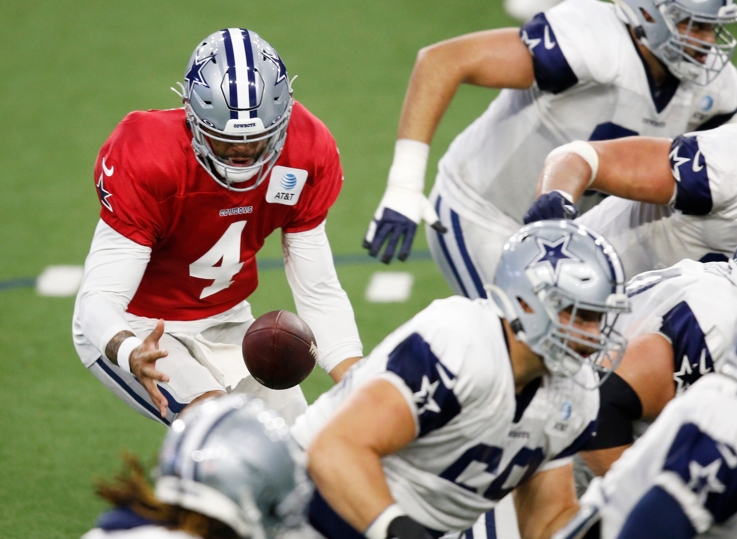 Dallas Cowboys quarterback Dak Prescott (4) bobbles the snap on a play in practice during...