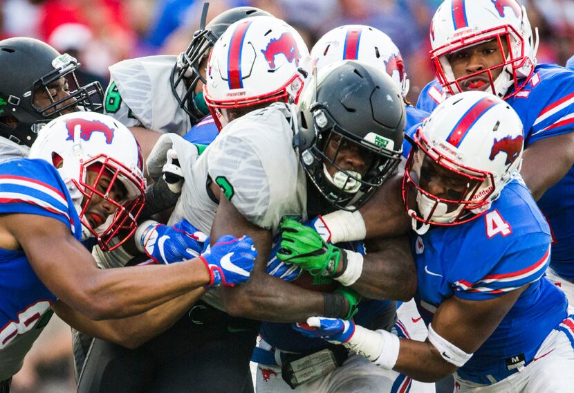 FILE - North Texas Mean Green running back Jeffery Wilson (3) is tackled by Southern...