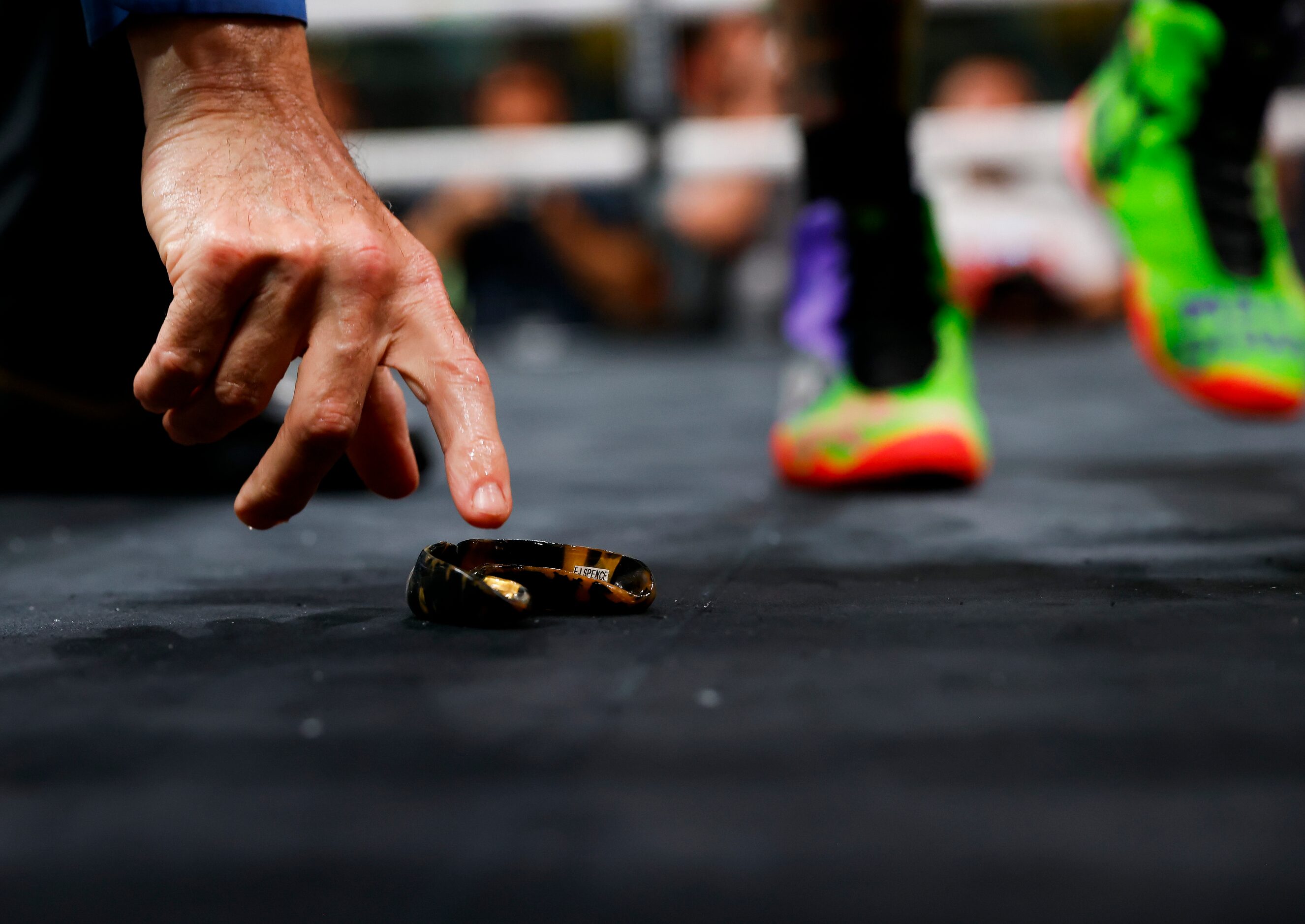 An official reaches for DeSoto’s Errol Spence Jr.’s mouth guard after Yordenis Ugas nocked...