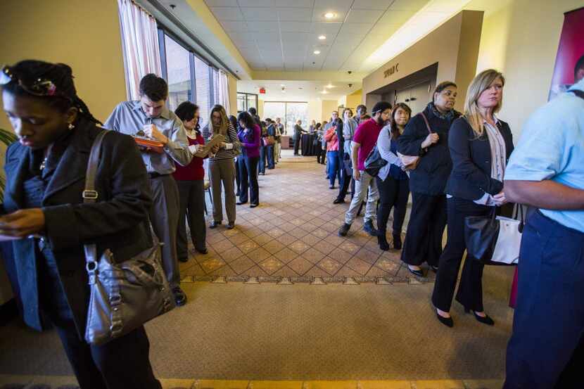  Job applicants stood in lines at a State Farm Insurance job fair in January in Richardson....