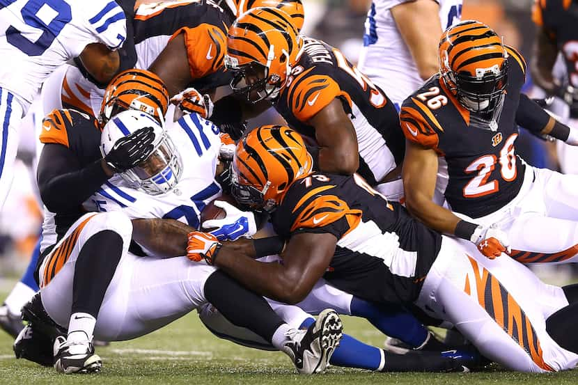 CINCINNATI, OH - AUGUST 28:  Christo Bilukidi #90, Trey Hopkins #73, and Marquis Flowers...