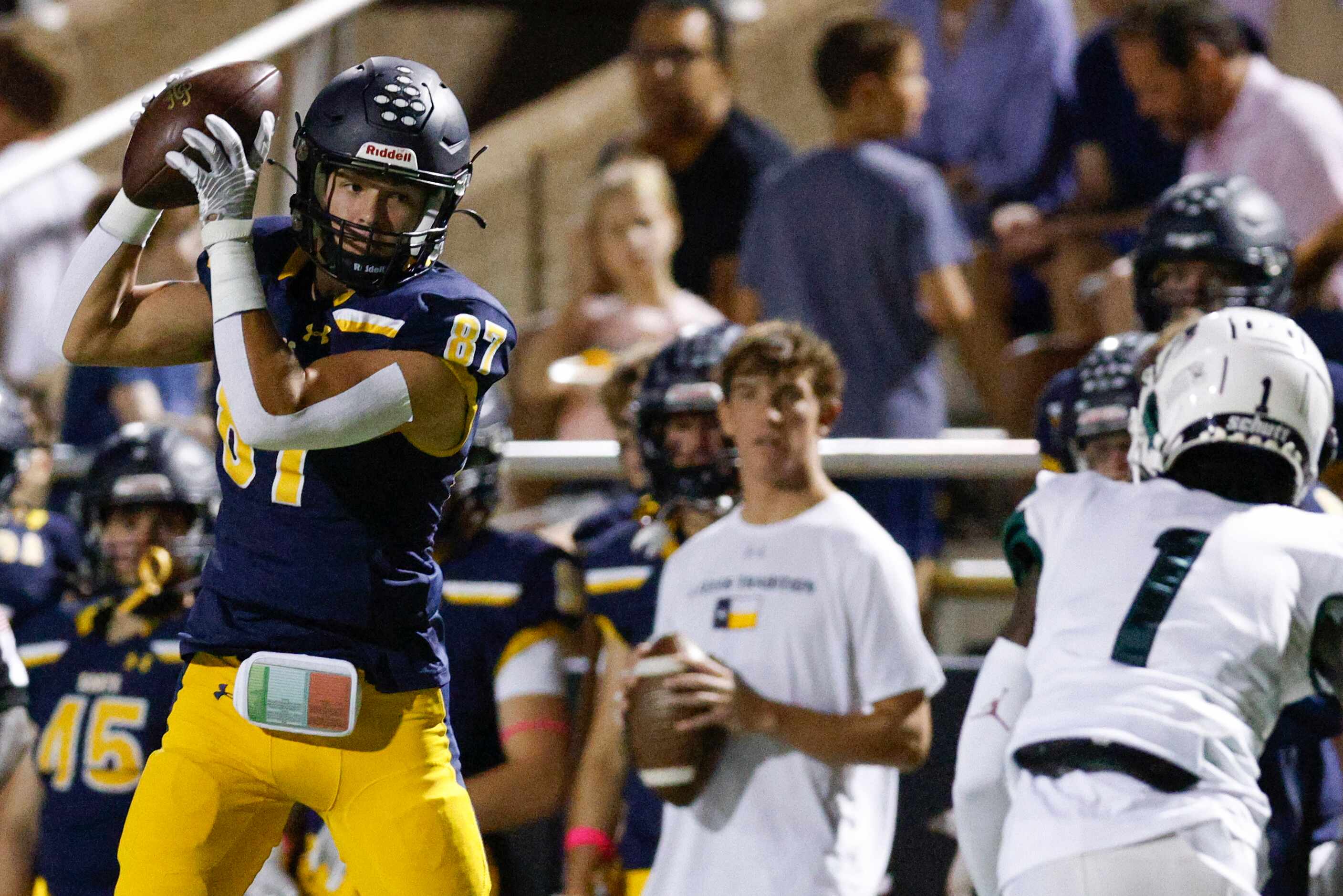Highland Park wide receiver Canon Spackman (87) catches a pass along the sideline during the...