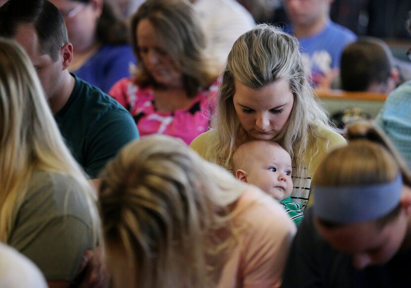 Church members sit in the pews during worship service at Arcadia First Baptist Church in...