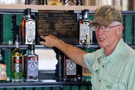 Les Beasley points to signatures on a memorial that lists all of the Medal of Honor...