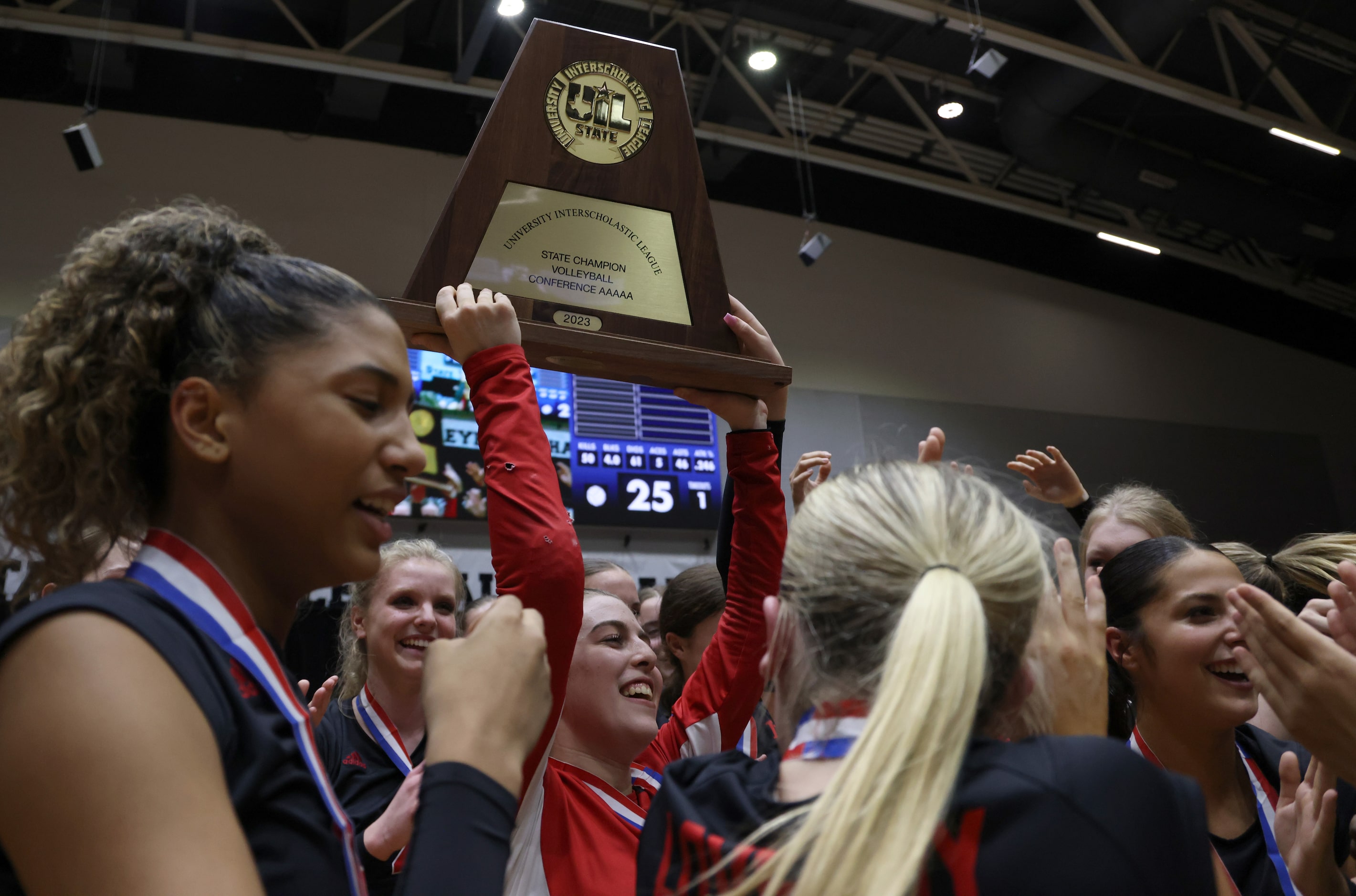 Lovejoy senior McKenna Brand (3) hoists the Class 5A state championship trophy as she...