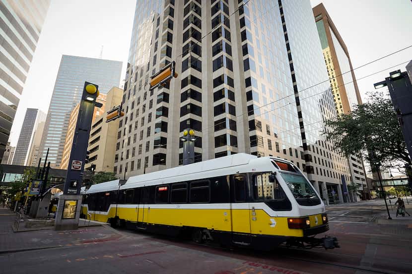 A DART rail train departs St. Paul Station in front of Harwood Center.