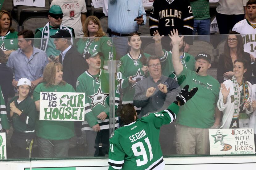 Dallas Stars center Tyler Seguin (91) tosses a puck to the fans before the first period of...