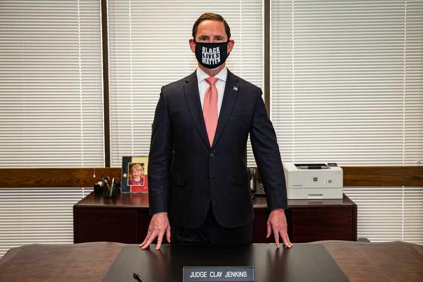 Dallas County Judge Clay Jenkins poses at his office after a news conference about the...