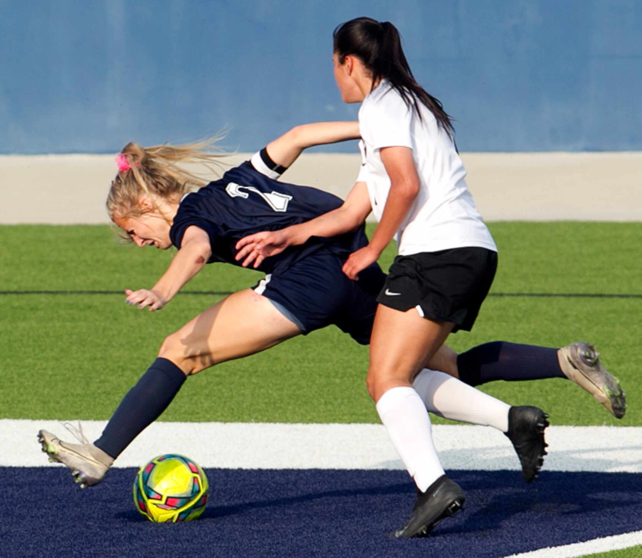 Flower Mound's Madison Schott (2) struggles to keep her balance after colliding with Flower...