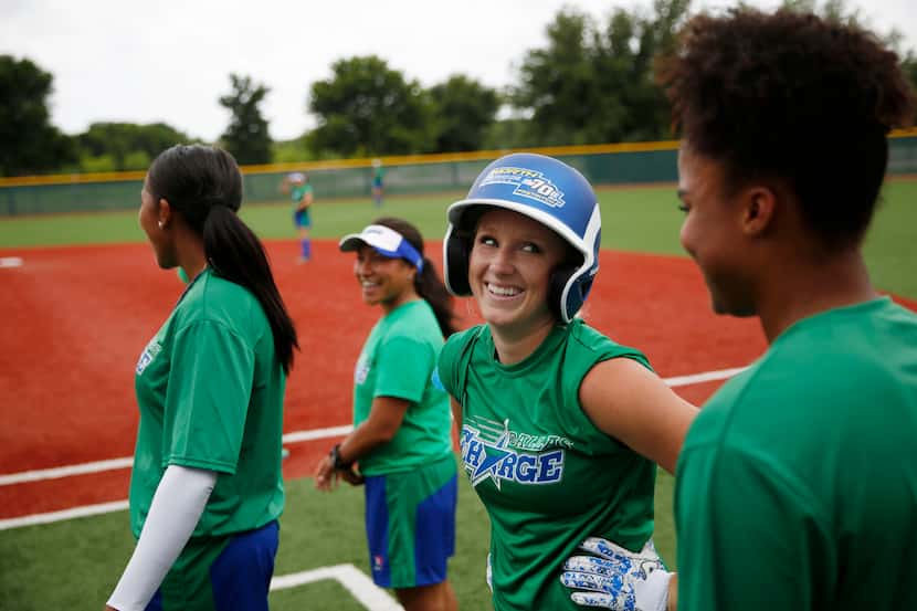 Dallas Charge shortstop Taylor Thom (center) speaks with outfielder Brianna Cherry during a...