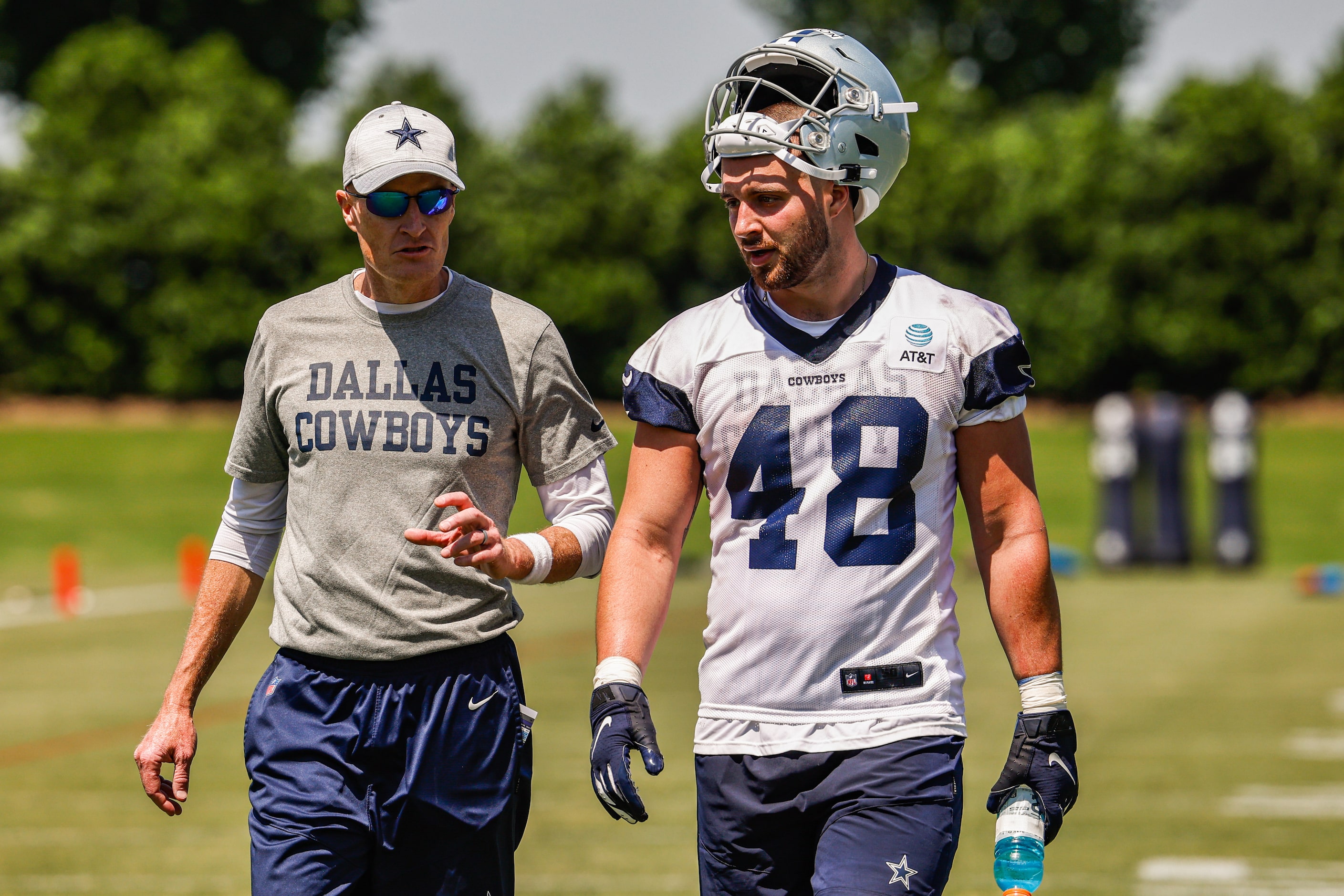 Dallas Cowboys offensive line coach Joe Philbin with tight end (48) Jake Ferguson as they...