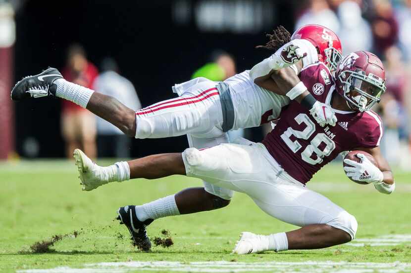 Texas A&M Aggies running back Isaiah Spiller (28) is tackled by Alabama Crimson Tide...