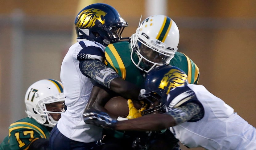 Madison wide receiver Danny Gray (5) is wrapped up by Life Oak Cliff defensive backs Malik...