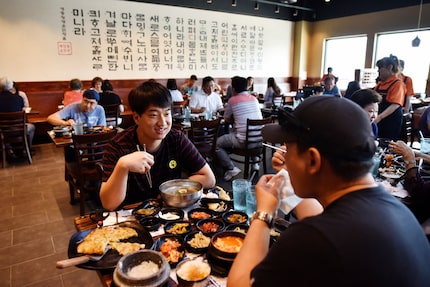 Chan Woo, 22, and Andy Kin, 46, both of Lewisville, enjoy lunch at BCD Tofu House in...