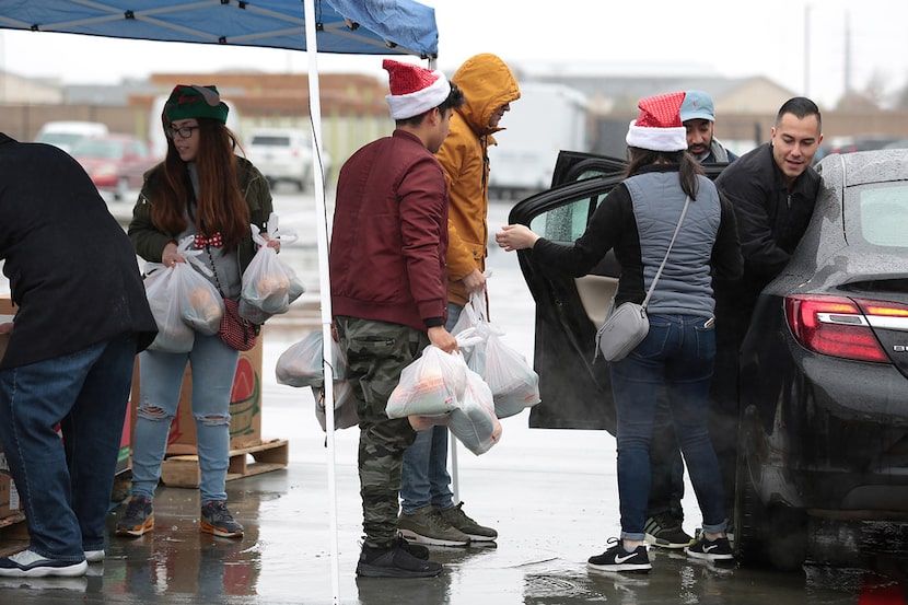 At the North Texas Food Bank, where volunteers helped load food in December, donations from...