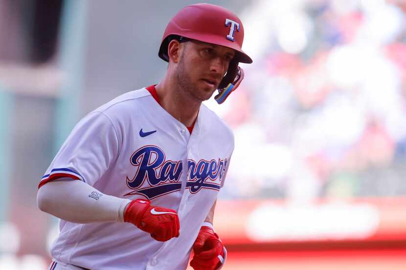 Texas Rangers catcher Mitch Garver runs between bases after hitting a home run during the...