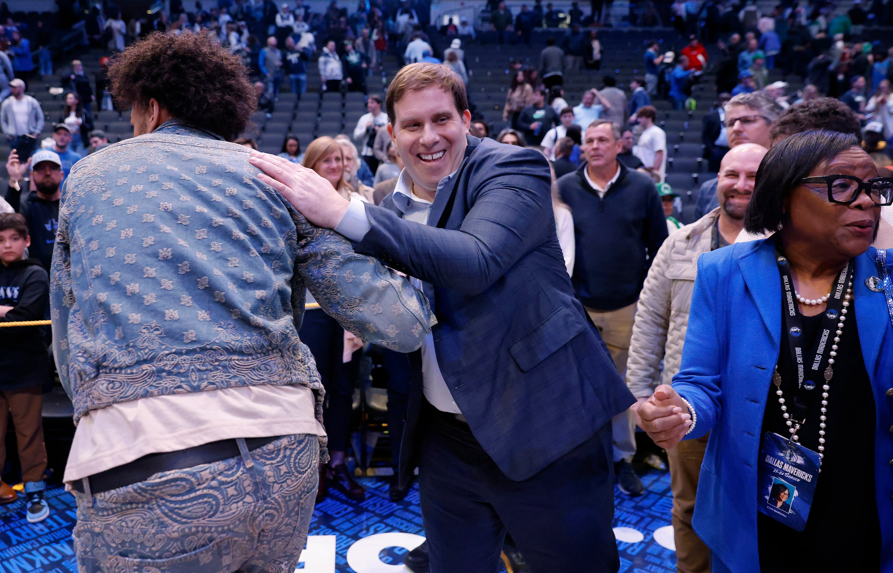 Dallas Mavericks new governor and majority owner Patrick Dumont (center) pats injured...