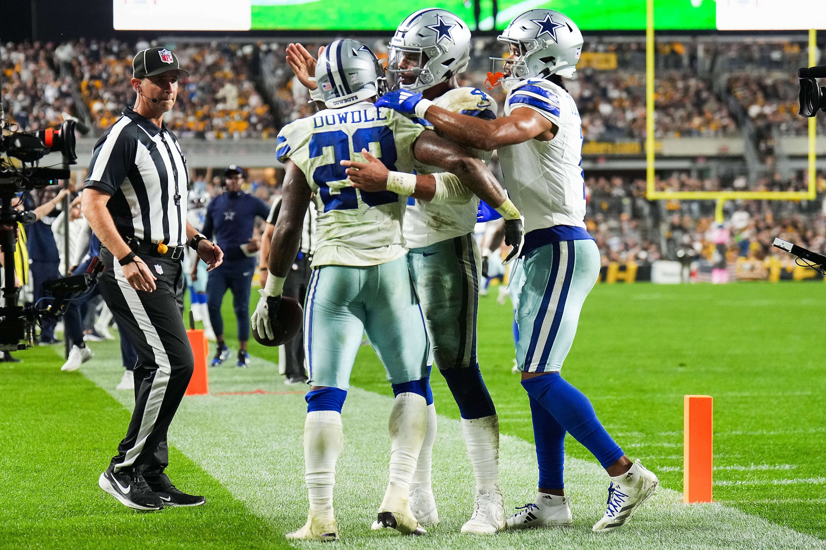 Dallas Cowboys running back Rico Dowdle (23) celebrates with quarterback Dak Prescott (4)...