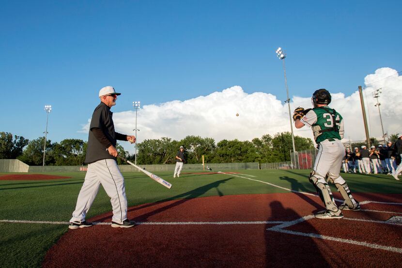 Prosper head coach Rick Carpenter conducts infield practice before a high school baseball...