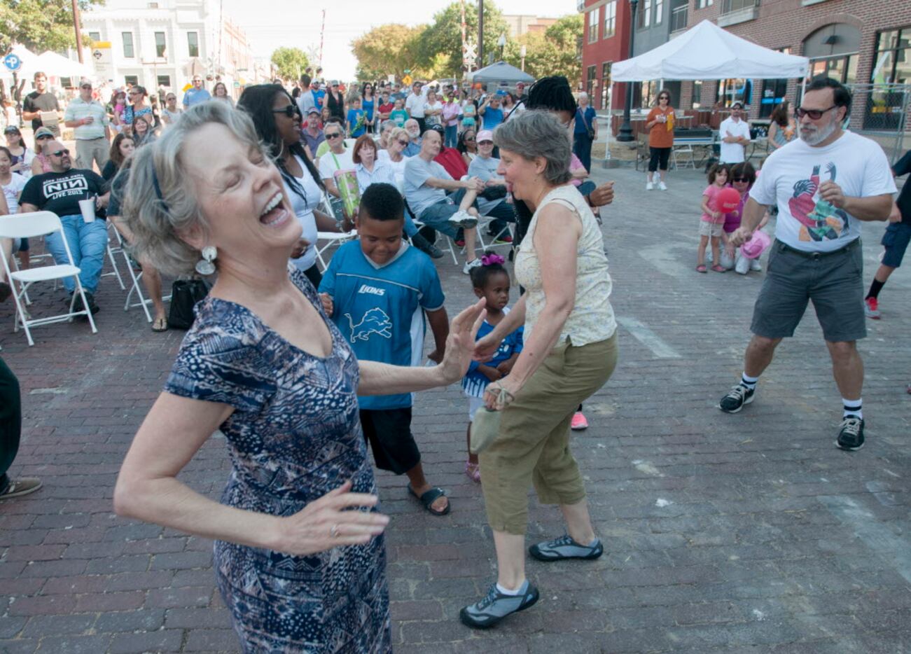 Melissa O'Neal dances the twist as Brave Combo performs in Downtown Plano.