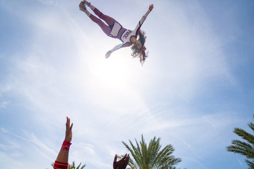 Trinity Valley Community College's Bella Guzman soars above her teammates during a routine.