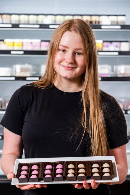 Nina Warda, 16, holds a tray of grab and go organic “noCheeseCake” dots at DessertsRx in...