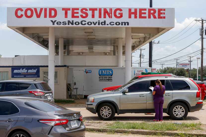 A health care worker speaks with someone getting a coronavirus test at a YesNoCovid testing...