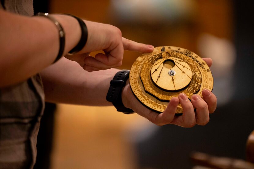 Alex Patrón, an industrial engineering sophomore, holds a replica of a volvelle from a 1534...