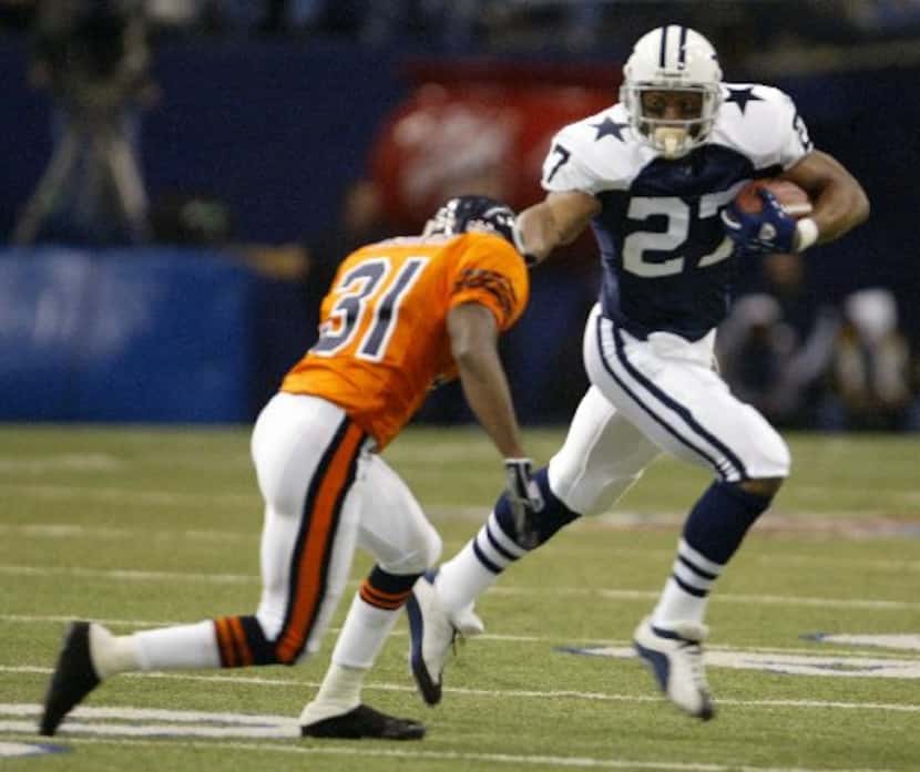 Dallas Cowboy Eddie George tries to get away from Chicago Bears defender Nathan Vasher  on...