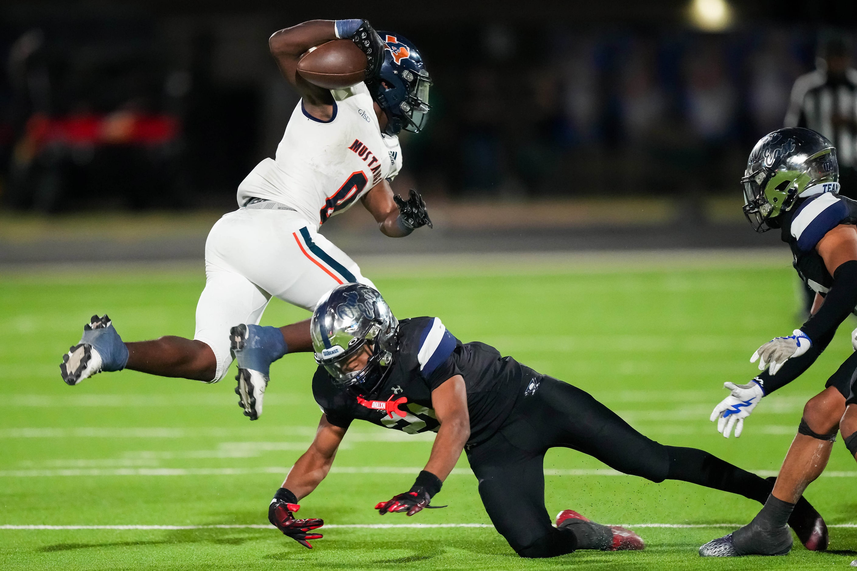 Sachse running back Brendon Haygood (0) leaps past Wylie East defensive back Michael...