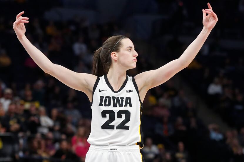 Iowa guard Caitlin Clark calls to the crowd for support after making two intentional foul...