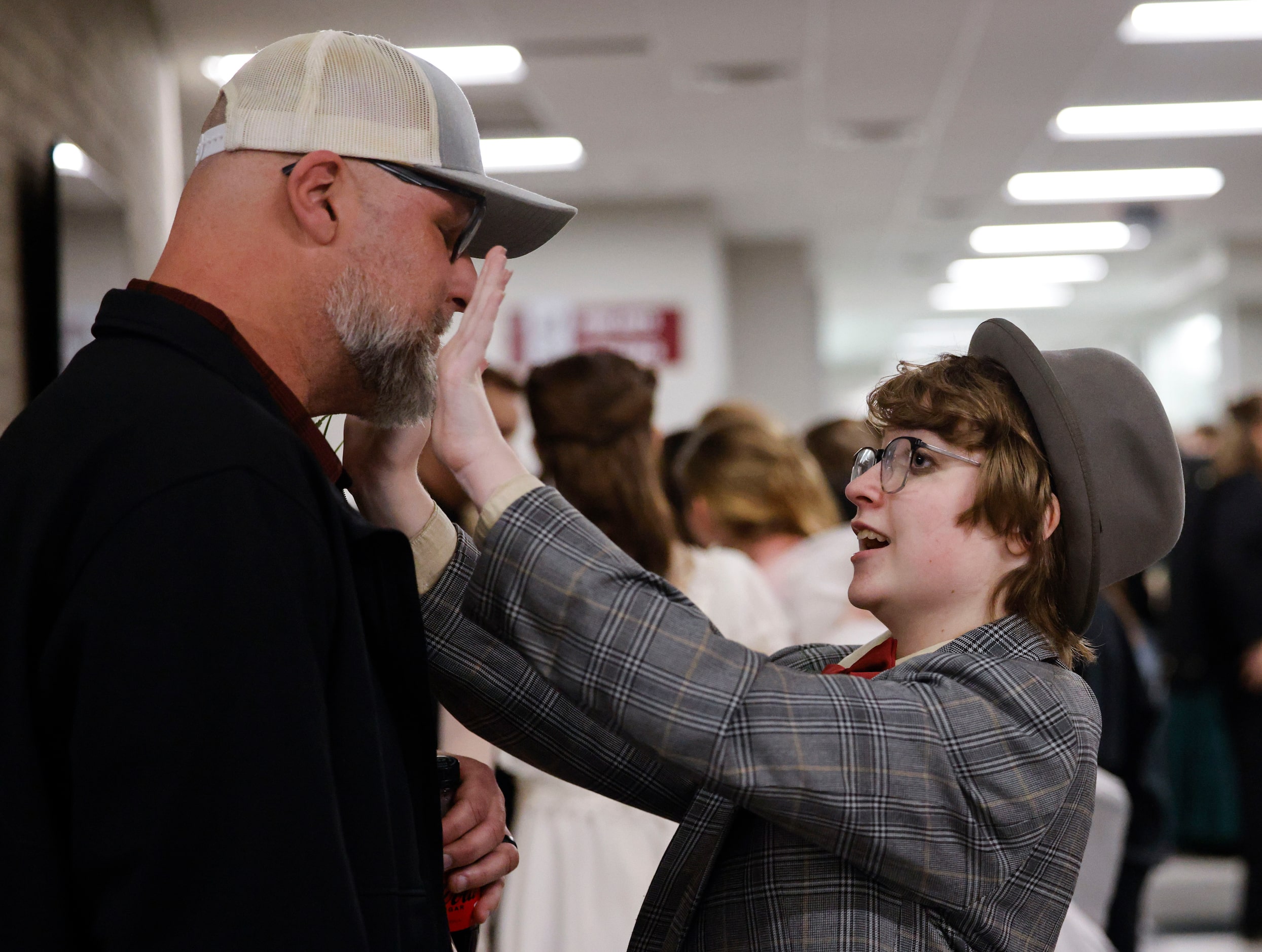 Phillip Hightower (left), looks towards his son Max, as he says “no more tears” following...