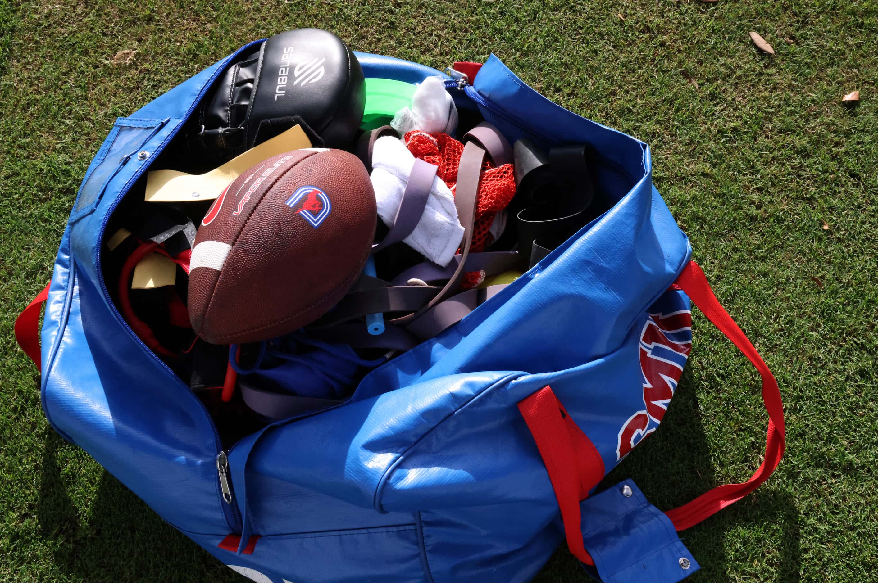 An SMU sport duffle bag filled with football accoutrements is within reach  along the...
