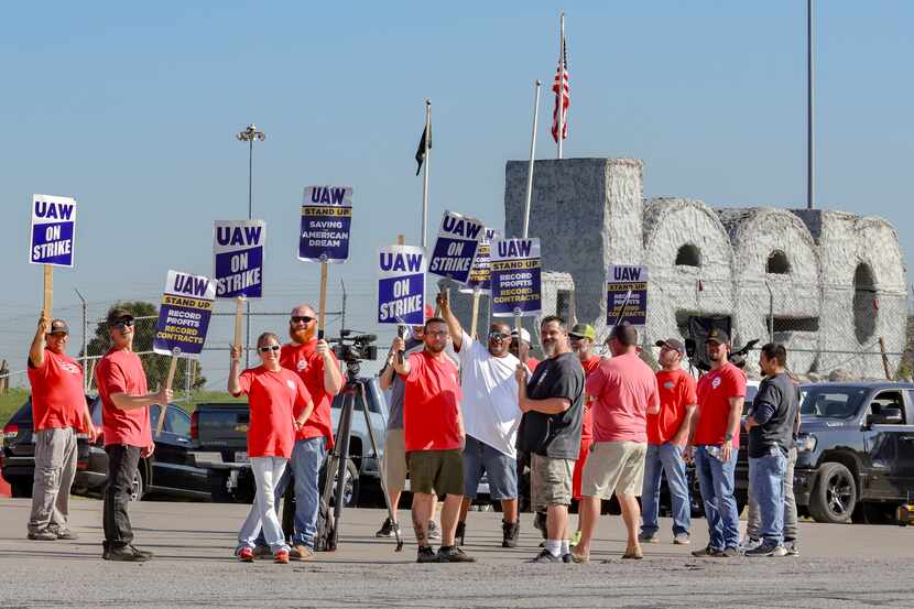 Striking United Auto Workers union members outside a Stellantis assembly plant in Toledo,...