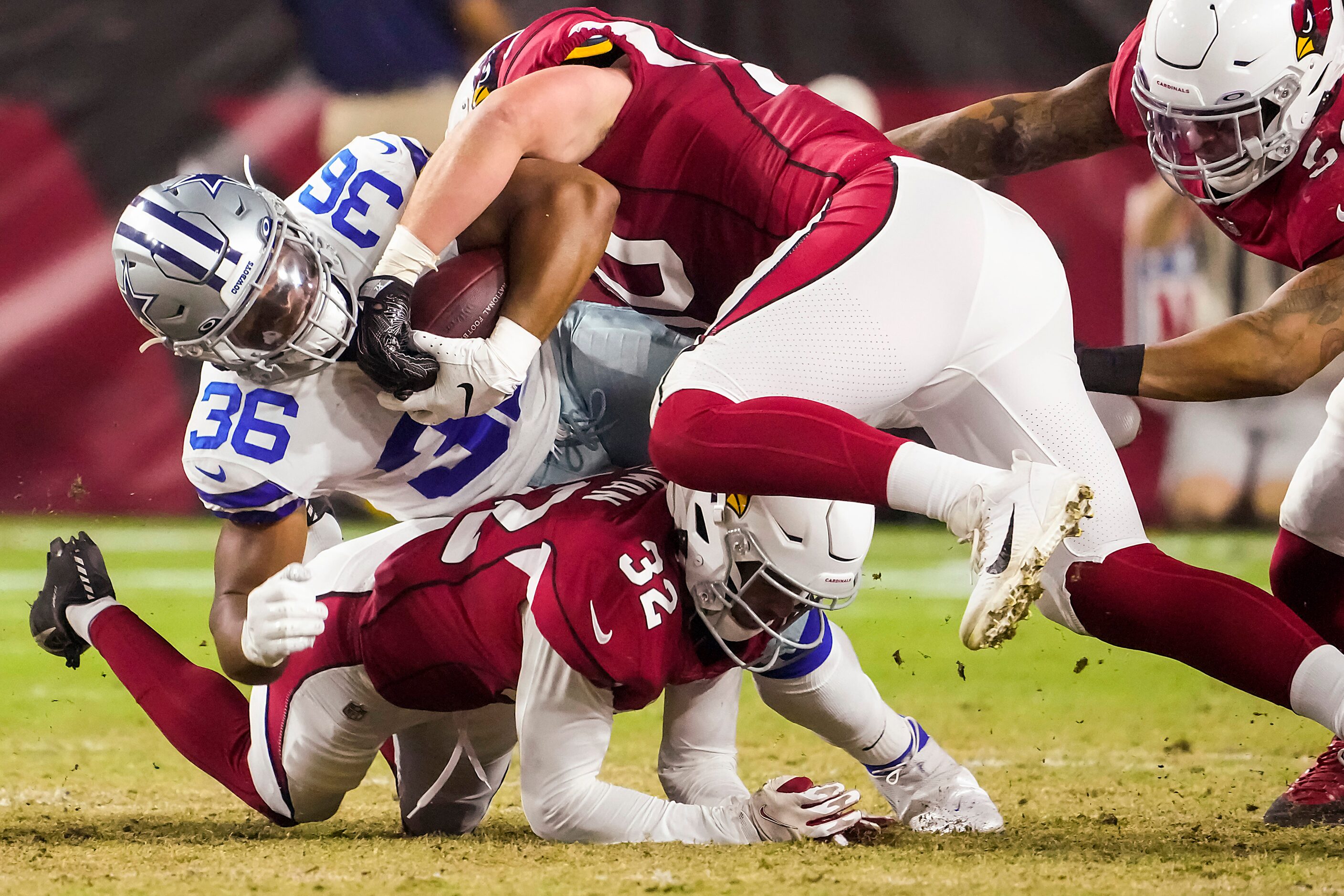 Dallas Cowboys running back Brenden Knox (36) is brought down by Arizona Cardinals...