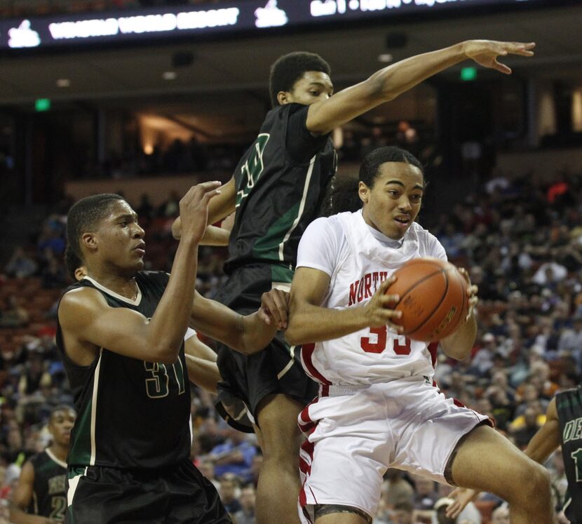 Desoto forward Terry Maston (31) and forward Devin Wyatt (20) try to defend Galena Park...