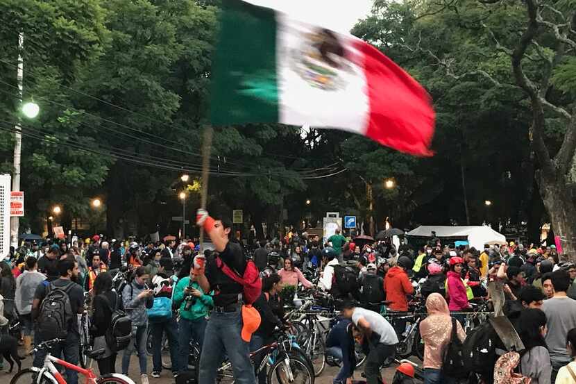 One lone Mexican stood atop a structure in Parque Mexico and flew the Mexican flag in...