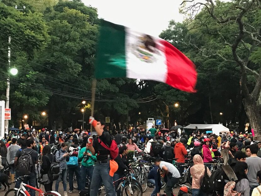 One lone Mexican stood atop a structure in Parque Mexico and flew the Mexican flag in...