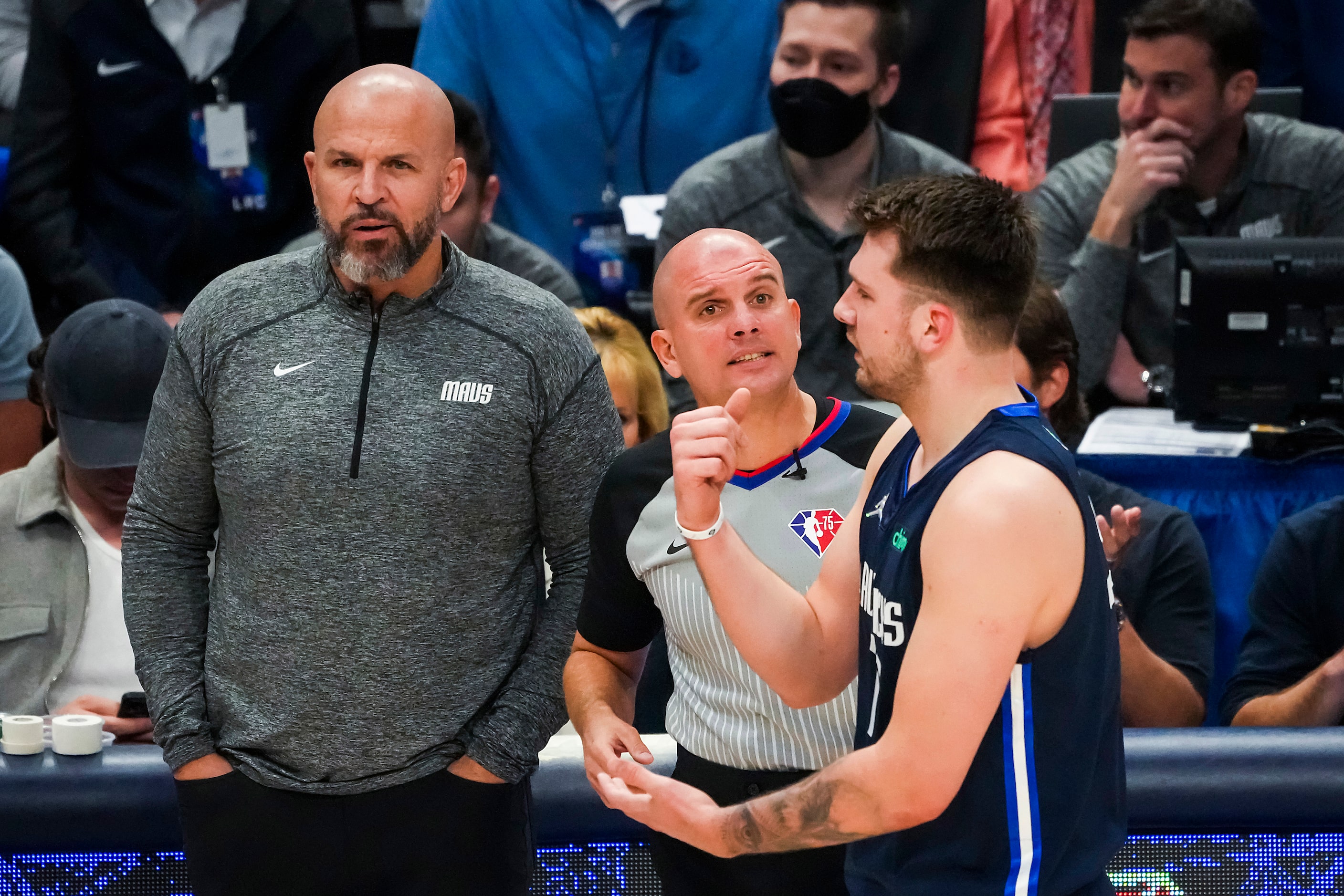 Dallas Mavericks guard Luka Doncic argues for a call as coach Jason Kidd looks on during the...