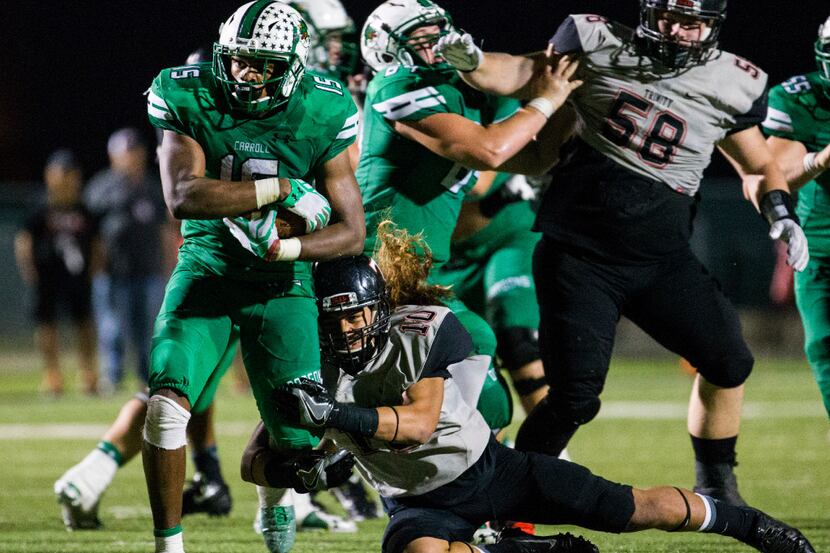 Southlake Carroll running back Audricke Gaines (15) is tackled by Euless Trinity linebacker...
