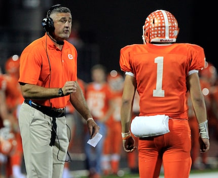 Celina Head coach Bil Elliott gives instructions to QB Nathan Elliott (1) during the second...