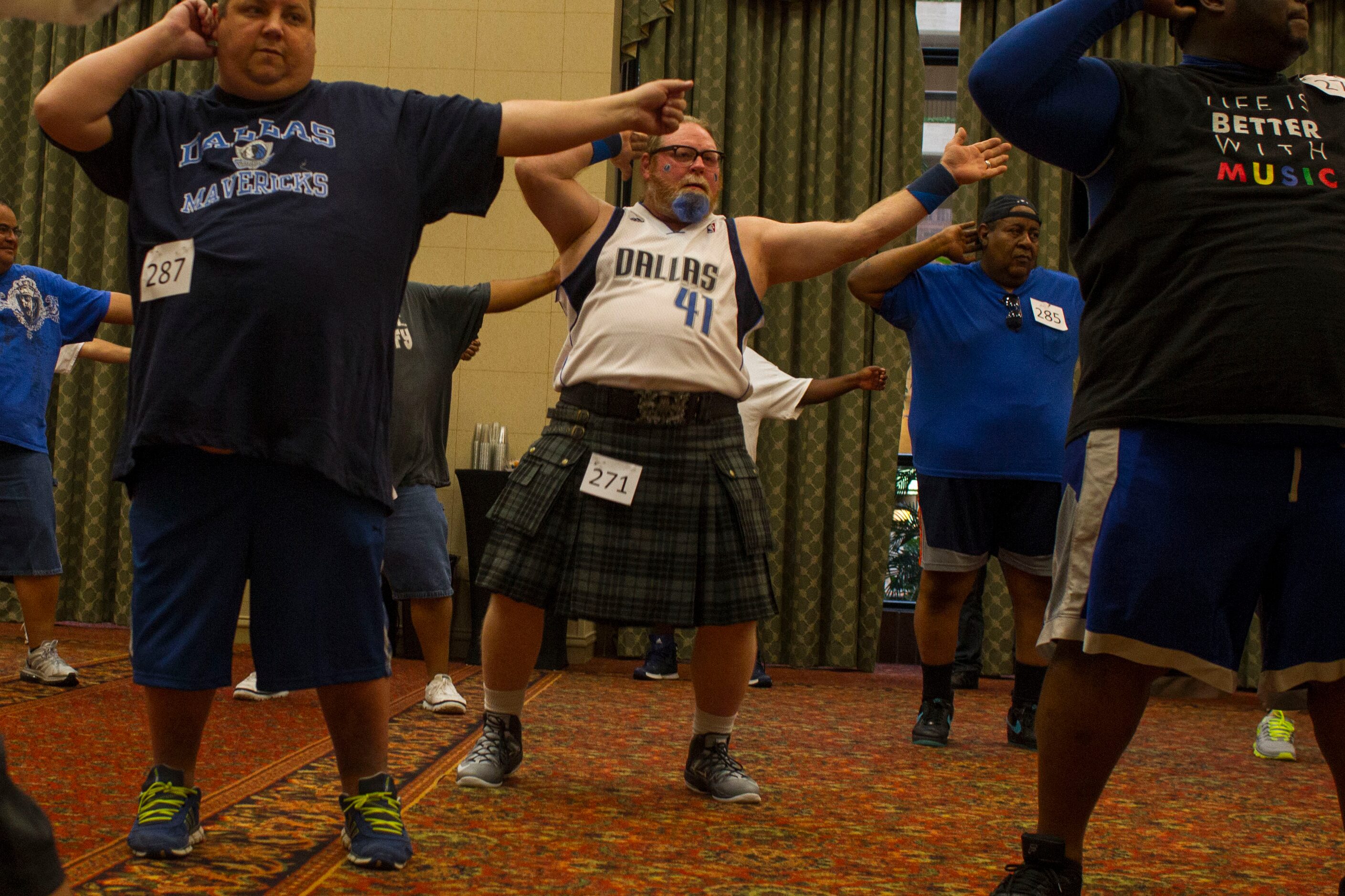 Donald McAfee, center, of Dallas, dances during The Mavs ManiAACs tryouts, which were held...