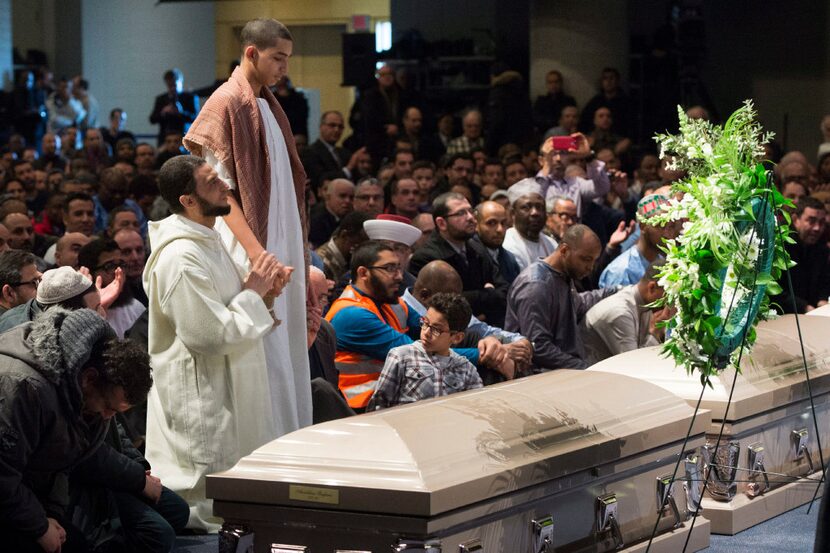 Ilies Soufiane stands next to the casket of his father Azzeddine Soufiane, one of the six...