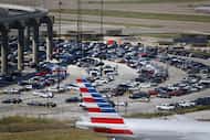 Travelers parked cars outside of DFW International Airport.