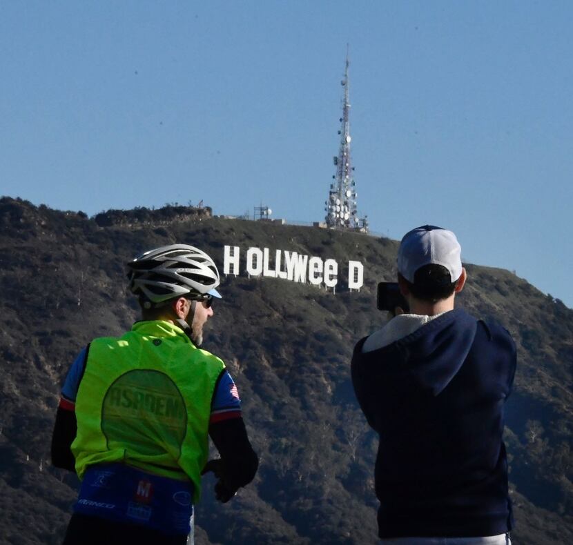 Onlookers snapped photos of the altered Hollywood sign before park rangers fixed the...