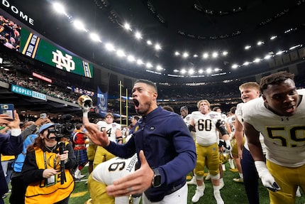 Notre Dame head coach Marcus Freeman celebrates with fans after quarterfinal game against...