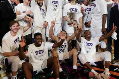 The TCU men's basketball team celebrates after beating Georgia Tech in the NIT final...