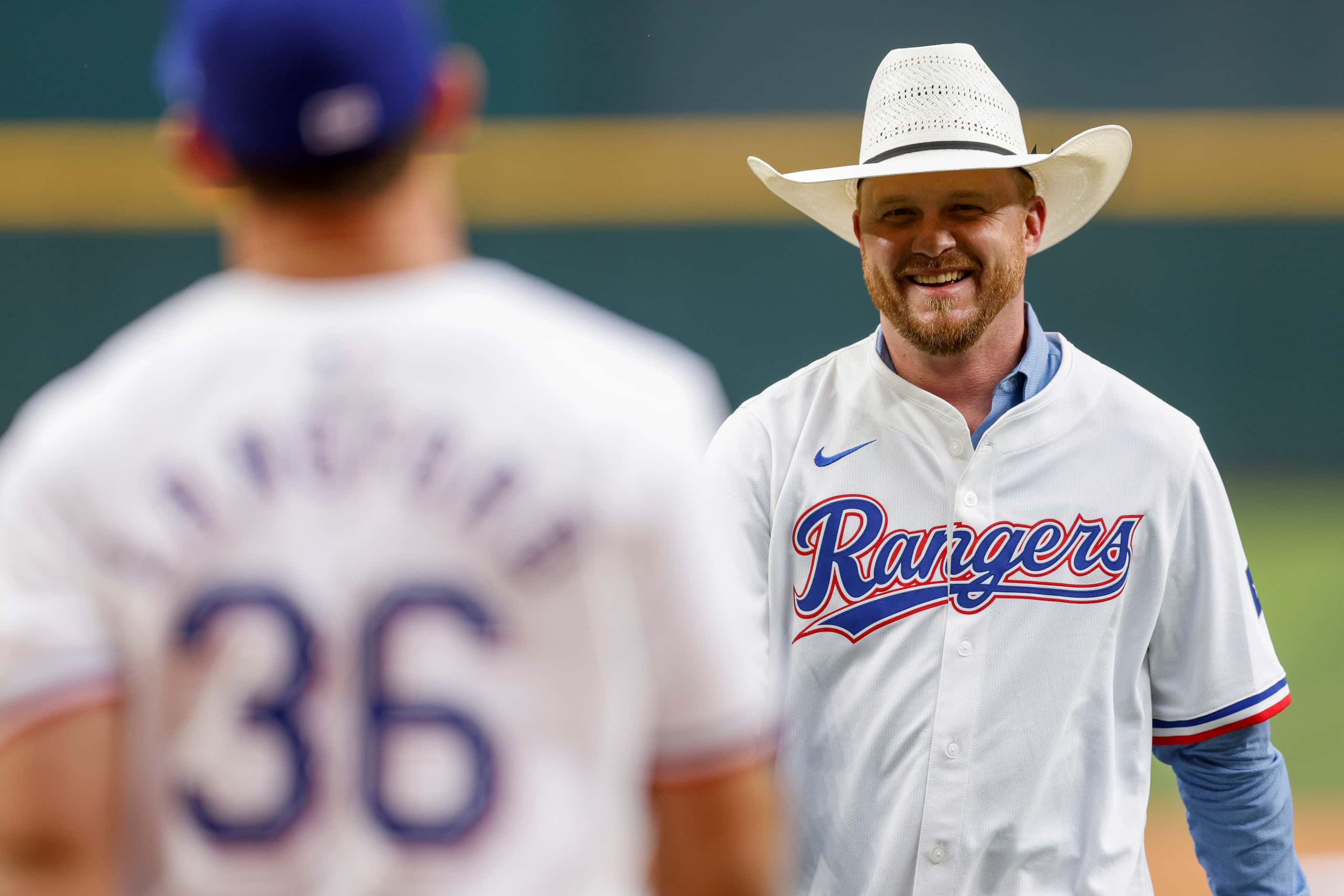 Country music singer Cody Johnson smiles after throwing the ceremonial first pitch to Texas...