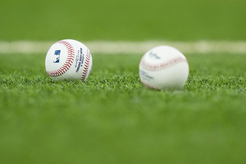 Baseball rest in the grass before a game between the Texas Rangers and the Seattle Mariners...
