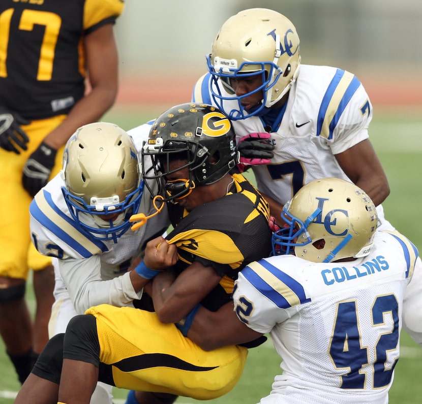 Garland's Jaylon Haskins (5) is tackled by Garland Lakeview's Tony King (12), Dejon Jeffery...